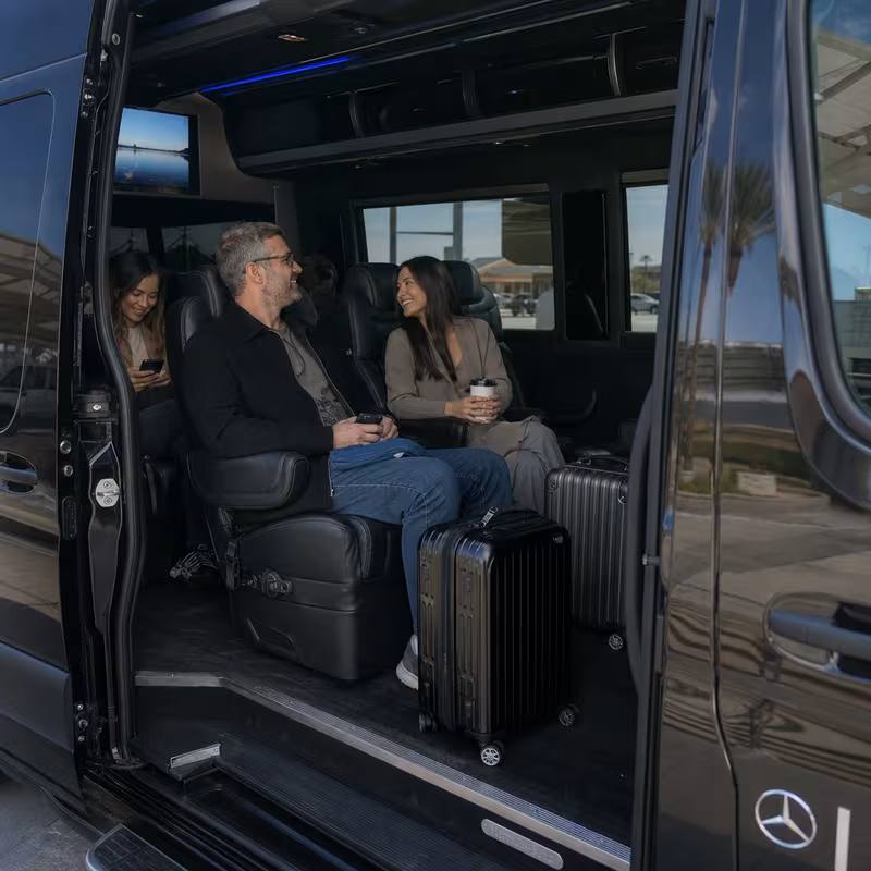 Passengers loading luggage while boarding an Glendale group shuttle