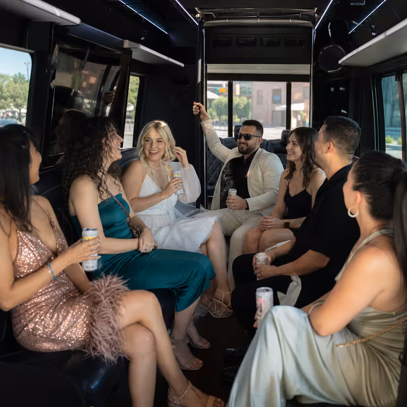 Party bus interior with wraparound leather seating and LED lighting in Glendale