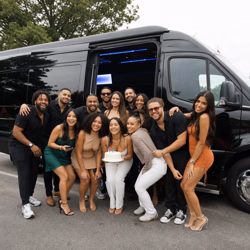 Group boarding a white charter bus for Birthday Transportation transportation in Glendale