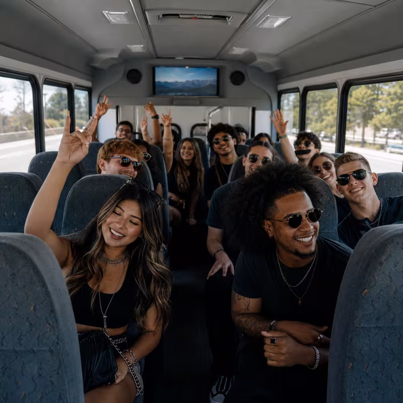 Party bus interior with wraparound leather seating and LED lighting in Glendale
