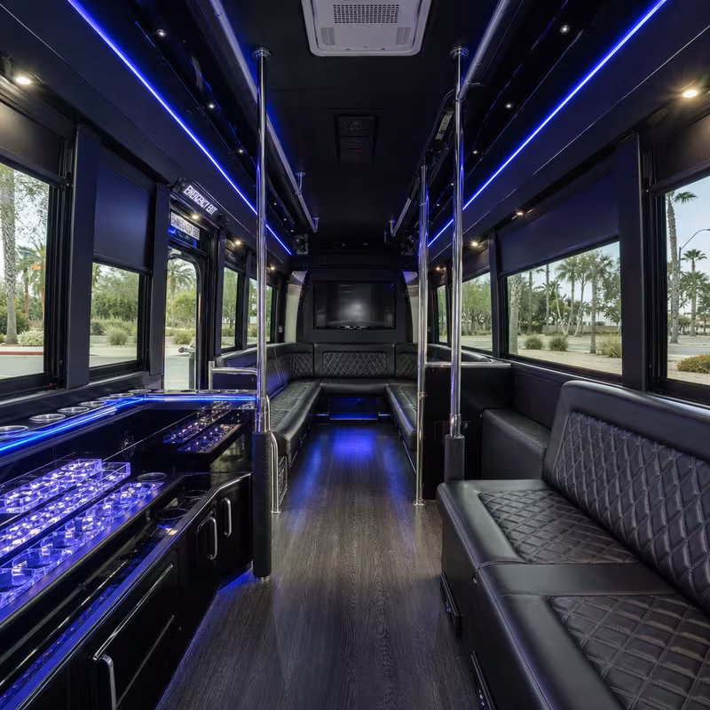 Party bus interior with wraparound leather seating and LED lighting in Glendale
