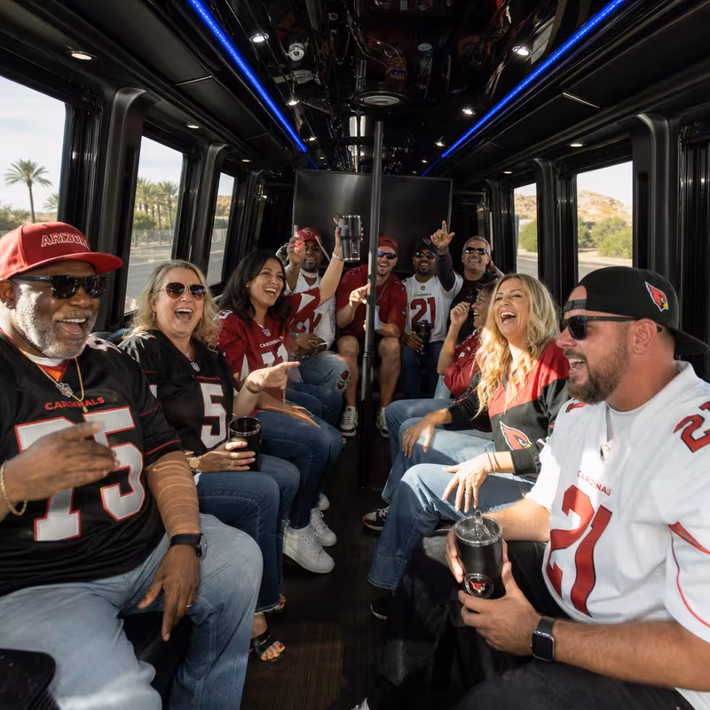 Group boarding a white charter bus for Sporting Event Transportation transportation in Glendale