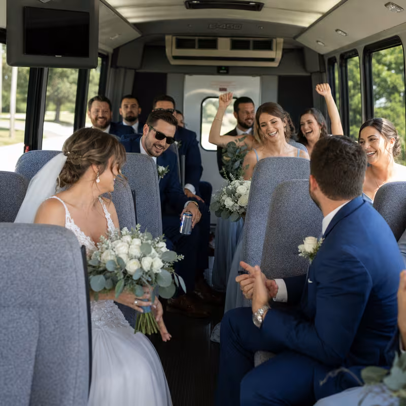 Group boarding a white charter bus for Wedding Transportation transportation in Glendale
