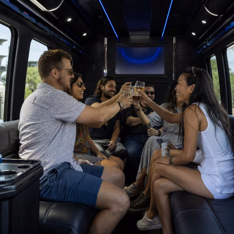 Group boarding a white charter bus for Winery & Brewery Tour Transportation transportation in Glendale