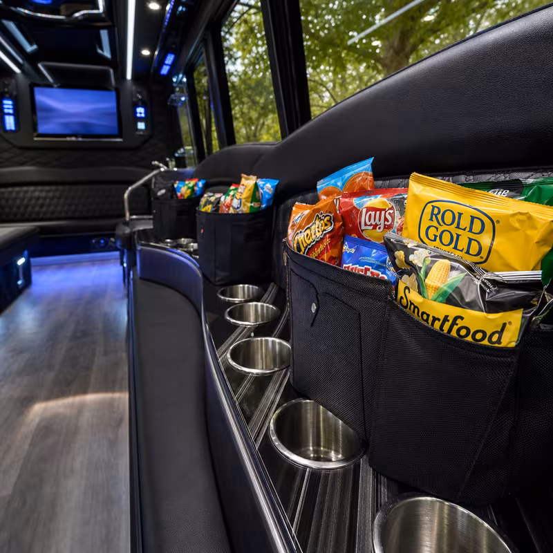 Party bus interior with wraparound leather seating and LED lighting in Glendale